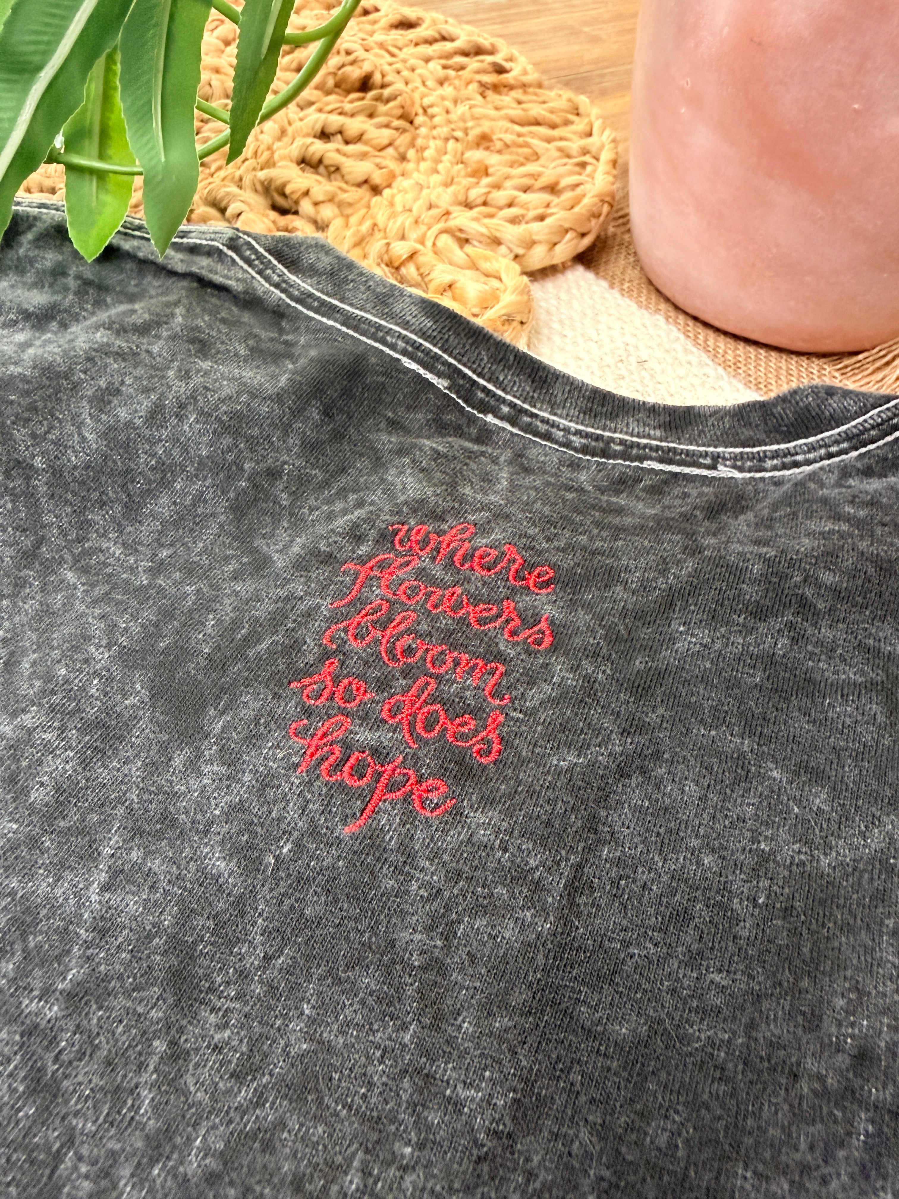 A washed black canvas with story stitched into every detail. The Midnight Bloom Tour Tee is designed to feel like something collected over time—soft, worn, and quietly striking. Three thoughtfully placed embroidery moments create movement across the garment, giving it that imperfect, artful balance that feels both elevated and undone.