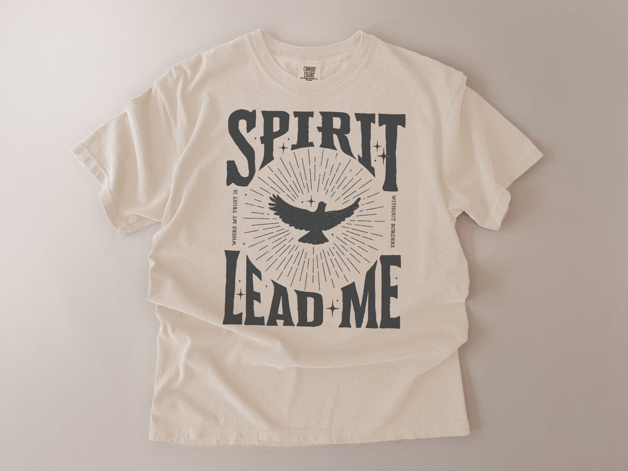 Beige t-shirt with 'Spirit Lead Me' graphic design on a plain background