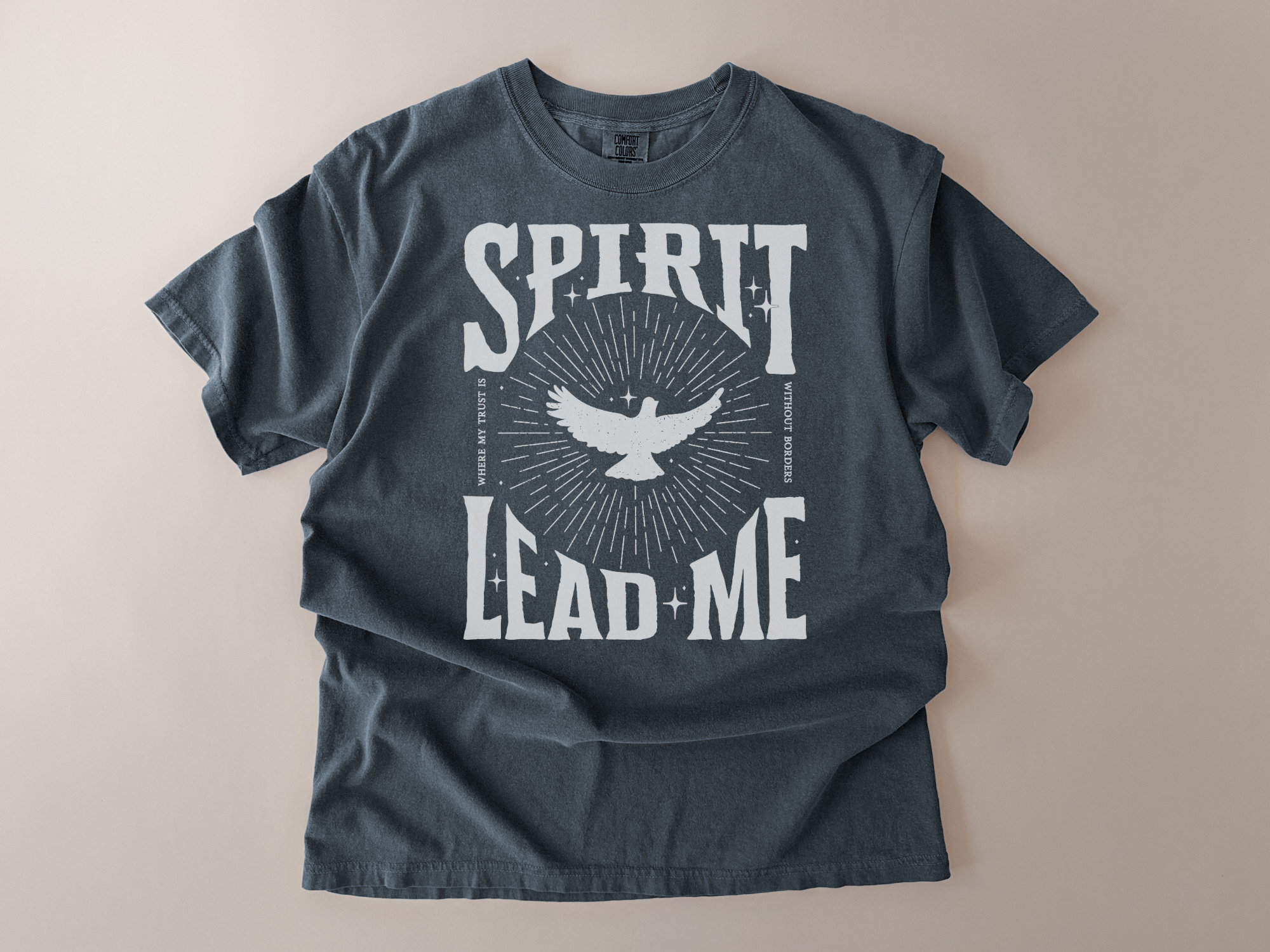 Dark gray t-shirt with 'Spirit Lead Me' graphic design on a beige background